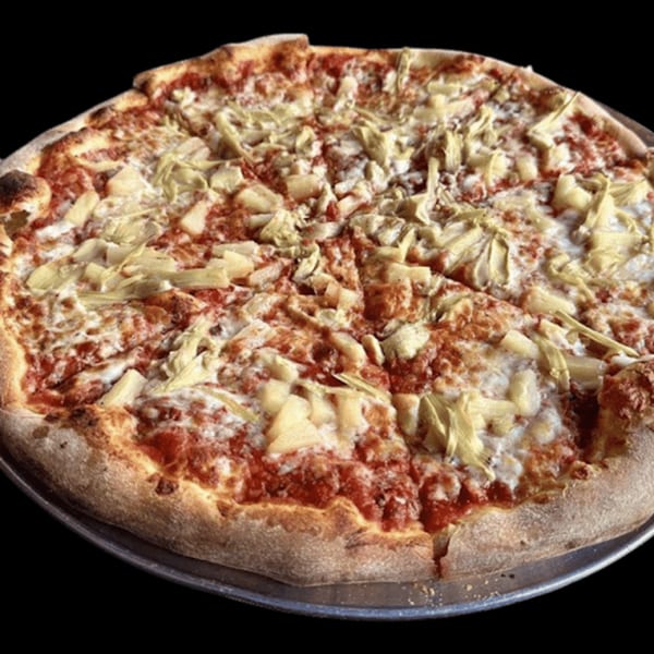 A whole, sliced pizza from The Kitchen Italian Cafe & Pizzeria, topped with artichoke hearts and pineapple.